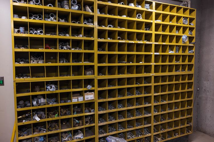 Rows of yellow parts bins holding plumbing fittings